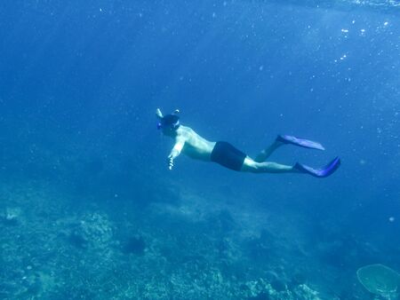 Underwater photo of woman snorkeling and free diving