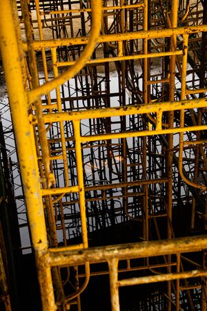 Scaffolding on building. Building covered in scaffolding at construction siteの写真素材