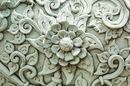 Beautiful traditional Thai style stucco wild flower vine patterned for decorative on wall backgroundの写真素材