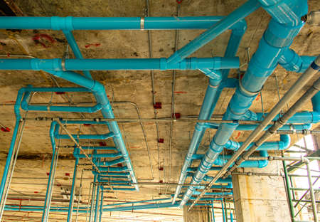 water pipes pvc plumbing under cement ceiling of second floor in construction site building