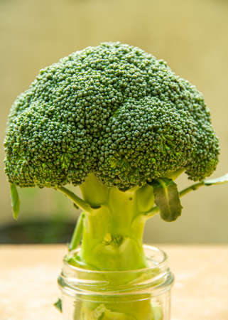 Beautiful broccoli crowns on a wooden board.
