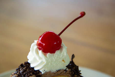 closeup chocolate cake with cherry on  wooden backgroundの写真素材