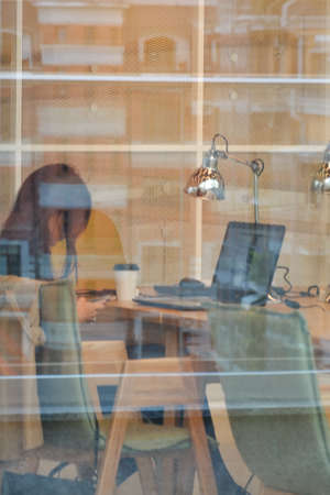 Kazan, Russia, September 16, 2020. A young woman is sitting at a laptop in the library.のeditorial素材