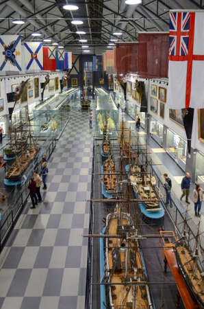 Saint Petersburg, Russia - 30 December, 2015. Exhibition of models of old ships and flags of the navy of different countries. People view the exhibits.のeditorial素材