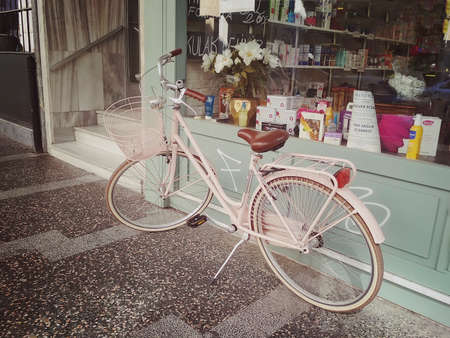 Istanbul, TURKEY - September 21 - 2018: Pink city bike with a basket in front near the pharmacy showcaseのeditorial素材