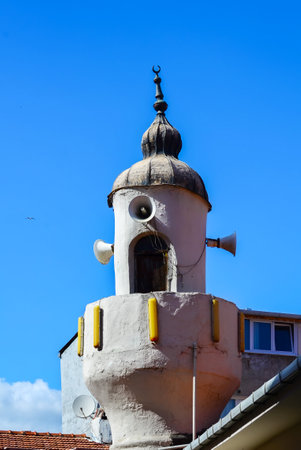 An old Minaret of a small mosque against the blue sky in Istanbul.の写真素材