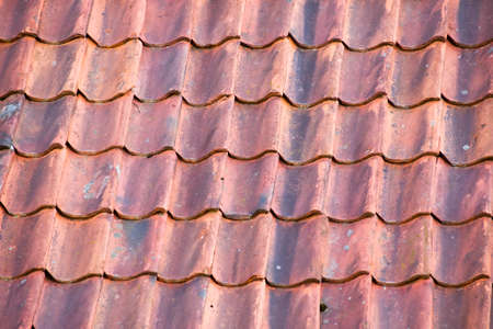 Background of red roof made of old tilesの写真素材