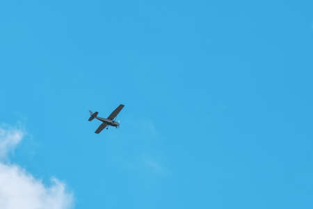 Small light aircraft flying in the blue skyの写真素材