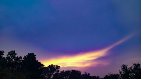 sky blue dark white and black clouds sun light tree beautifully wetherの写真素材