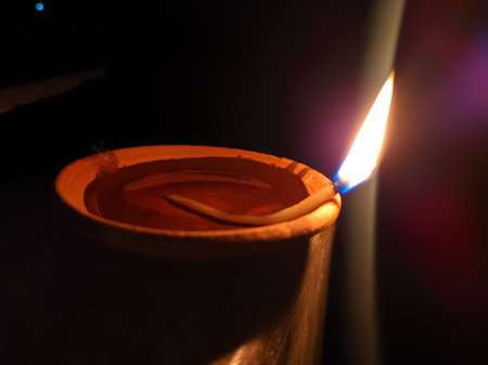 Glowing clay lamp and candle Happy diwali festive seasonÂ indian festival of dipawaliの写真素材
