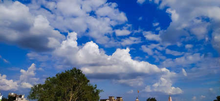 sky blue background image white clouds tree background image in indian village imageの写真素材
