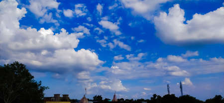 sky blue background image white clouds tree background image in indian village imageの写真素材