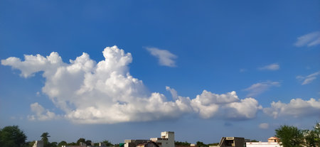 sky blue background image white clouds tree background image in indian village imageの写真素材