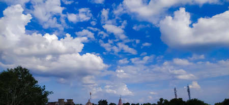 sky blue background image white clouds tree background image in indian village imageの写真素材