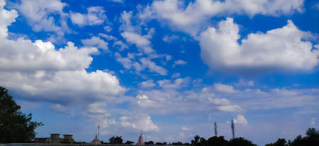 sky blue background image white clouds tree background image in indian village imageの写真素材