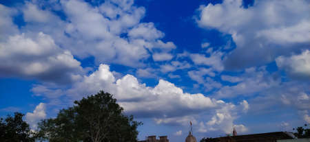 sky blue background image white clouds tree background image in indian village imageの写真素材