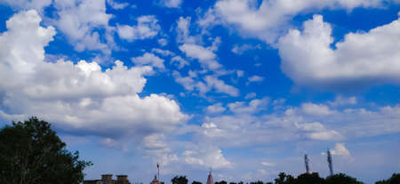 sky blue background image white clouds tree background image in indian village imageの写真素材