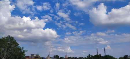sky blue background image white clouds tree background image in indian village imageの写真素材