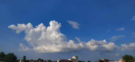 sky blue background image white clouds tree background image in indian village imageの写真素材