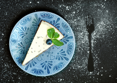 Cheesecake with blueberries on a black backgroundの写真素材