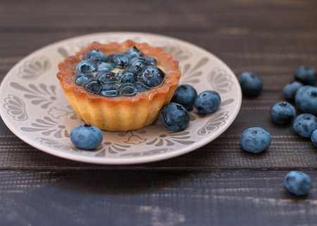 tart with blueberries on a wooden backgroundの写真素材