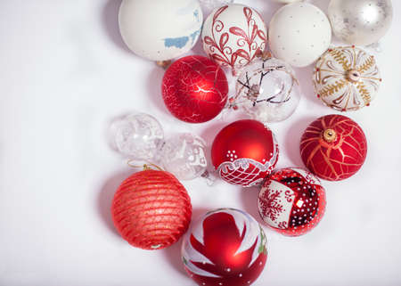 Red and white Christmas balls on a white background with different pictures on them. Christmas and New Year conceptの写真素材