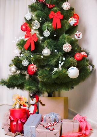 christmas tree with colorful balls and gift boxesの写真素材