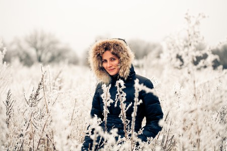 winter woman in a frozen plantの写真素材