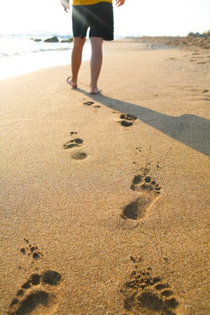 man walking on the beachの写真素材