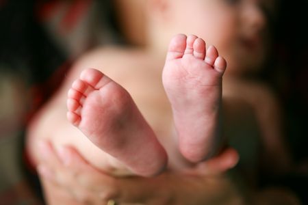 Mother holding her child's feet