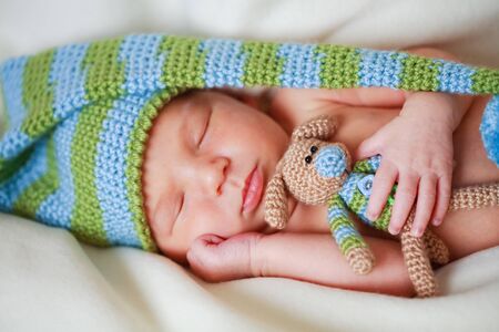 adorable newborn baby with teddyの写真素材