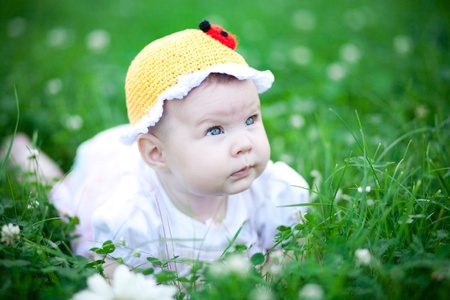 Adorable baby girl outdoors in the grassの写真素材