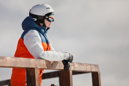 female snowboarder against sun and skyの写真素材