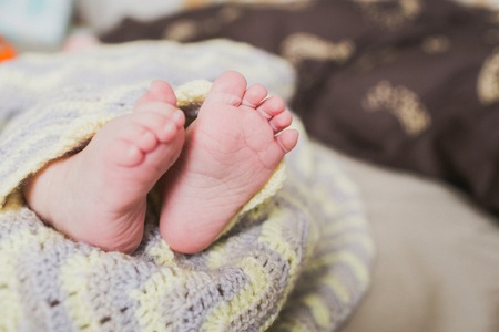 adorable newborn baby feetの写真素材