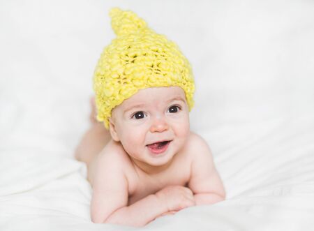 adorable newborn baby on a bedの写真素材