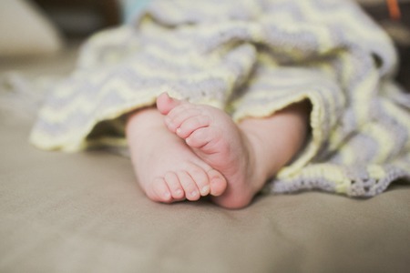 adorable newborn little baby feetの写真素材