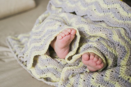 adorable newborn little baby feetの写真素材