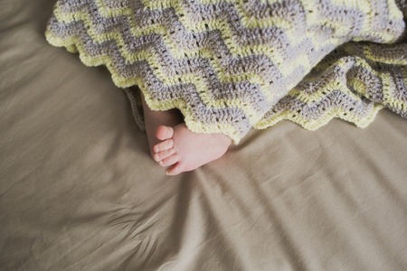 adorable newborn little baby feetの写真素材
