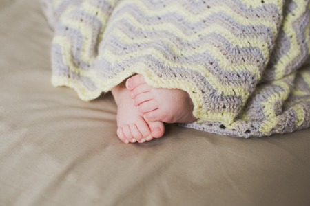 adorable newborn little baby feetの写真素材