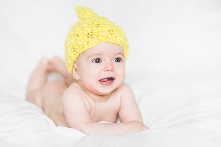 adorable newborn baby on a bedの写真素材