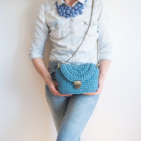 Close up photo of woman bag in hands of fashionable woman. Elegant outfit. Female fashion conceptの写真素材