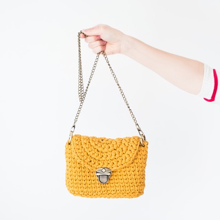 Close up photo of woman bag in hands of fashionable woman. Elegant outfit. Female fashion conceptの写真素材
