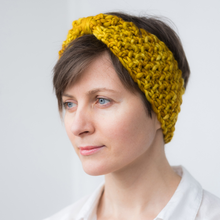 Beautiful young woman in knit warm headbandの写真素材