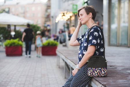 Close up photo of woman bag in hands of fashionable woman. Elegant outfit. Female fashion conceptの写真素材