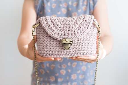 Close up photo of woman bag in hands of fashionable womanの写真素材