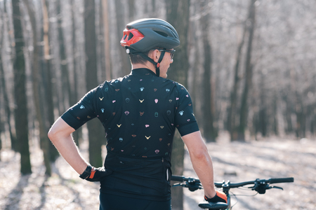 male athlete mountainbiker with bicycle along a forest trail. in forest mistの写真素材