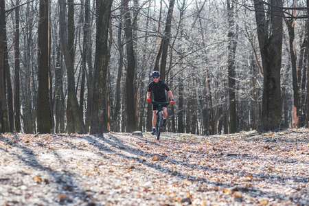 male athlete mountainbiker with bicycle along a forest trail. in forest mistの写真素材