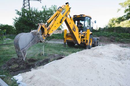 On construction site. Excavation, town.