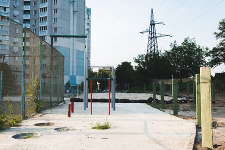 childrens playground with swings in courtyard of residential building in the cityの写真素材