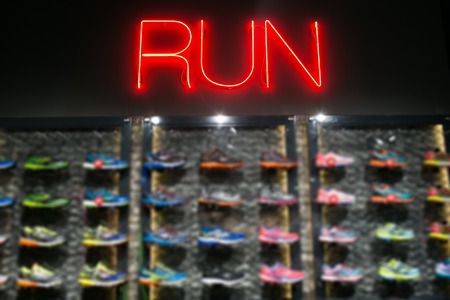 Trendy casual running shoes on dark background. Run, colorful posterの写真素材
